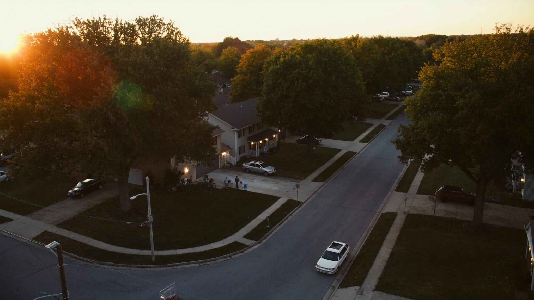 An aerial view of a Midwestern suburban neighborhood at golden hour