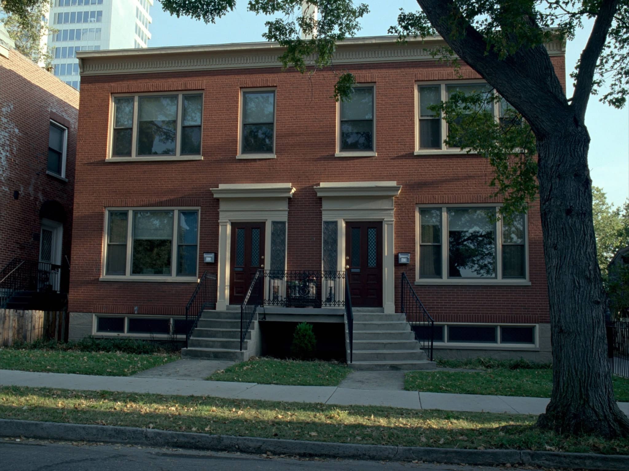 Well-maintained brick two-flat rental building on a tree-lined Chicago street
